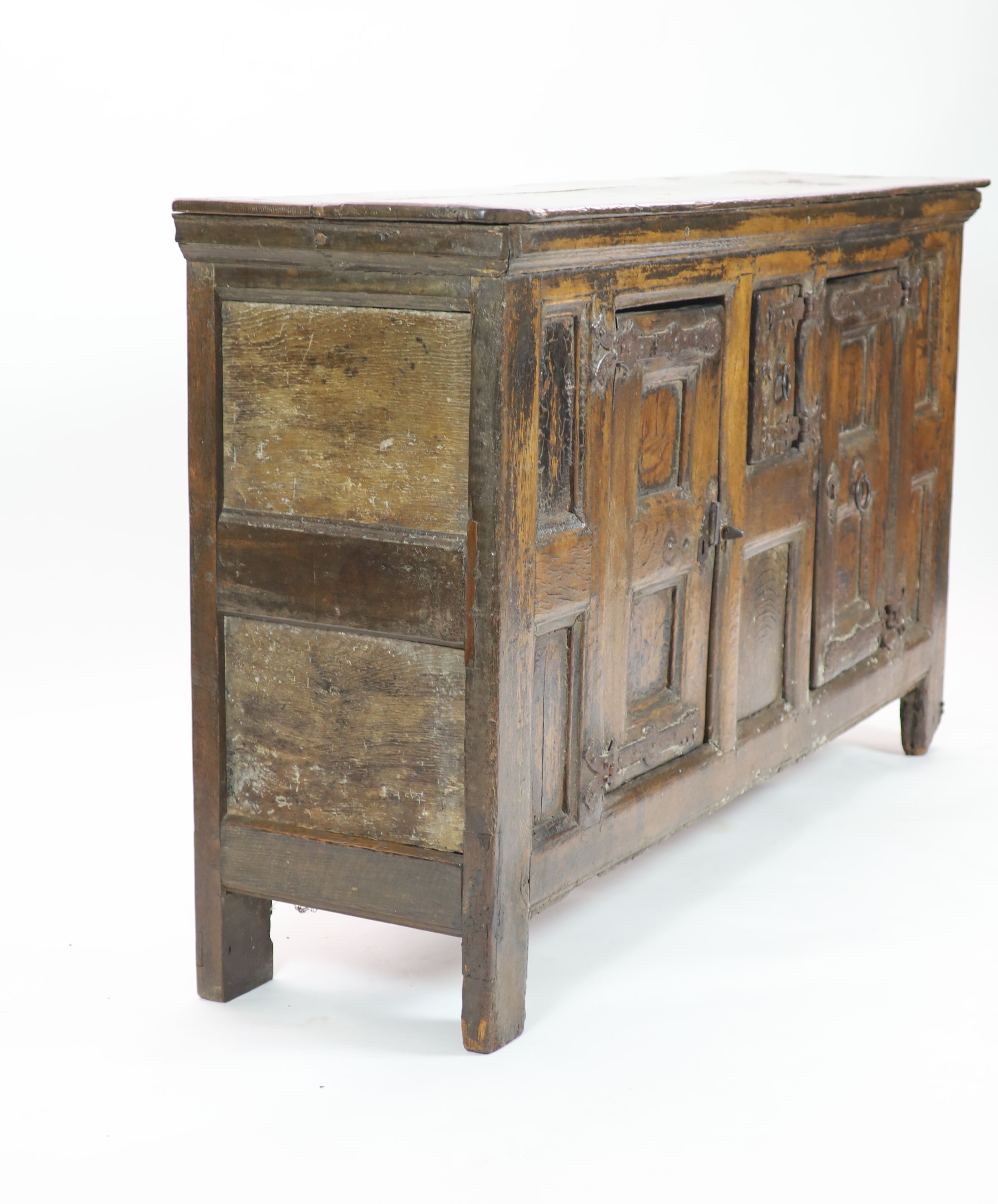 A late 16th/early 17th century German oak side cupboard H 104cm. W 185cm. D 49cm.